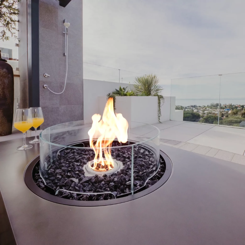 EcoSmart Fire R20 Screen installed on round outdoor fire table with active flame
