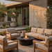 EcoSmart Mimosa 40 in Graphite Fluid concrete amid timber-framed outdoor sofas on a paved terrace, with a live flame.