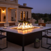 EcoSmart Linear 130 Fire Pit Kit seamlessly integrated into a stylish outdoor dining table, providing warmth and ambiance with the fire's glow.