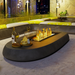 Close-up view of the EcoSmart Linear 50 Outdoor Fire Pit Kit flames flickering over the black glass rocks, highlighting the fire pit's high-quality construction and stylish finish
