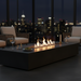 EcoSmart Linear 65 Fire Pit Kit shown in an outdoor setting during the night with a sleek modern look, flames dancing in the center