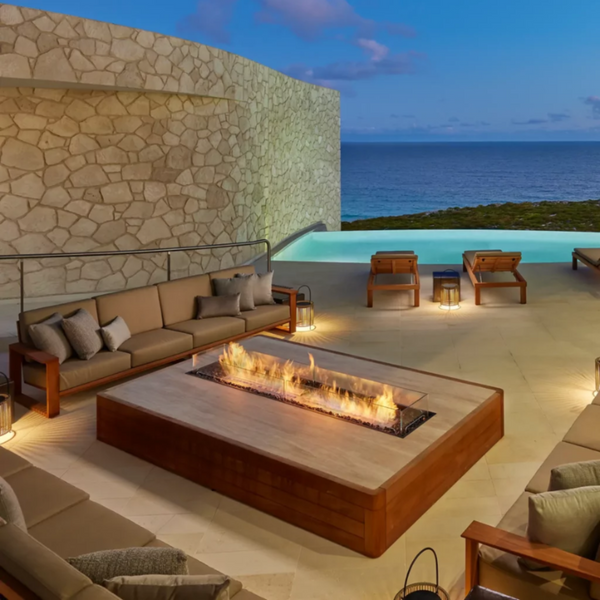 EcoSmart Linear 90 built into a timber-clad low table on a clifftop terrace above the sea