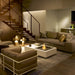 EcoSmart Manhattan 50 fire table in Bone fluid concrete in a staircase living room with designer furniture.