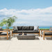 EcoSmart Manhattan 50 fire table in Graphite on an oceanfront terrace with an outdoor lounge setting.