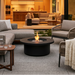 EcoSmart Mimosa 40 in Graphite Fluid concrete on a modern patio at dusk with woven outdoor chairs.