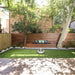EcoSmart Mix 600 fire pit bowl on a lawn in a landscaped backyard garden.