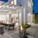 EcoSmart Mix 850 fire pit bowl in an alfresco dining courtyard beside a white weatherboard home.