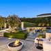 EcoSmart Mix 850 Fire Pit on a luxury poolside patio at dusk with seating and outdoor entertaining.
