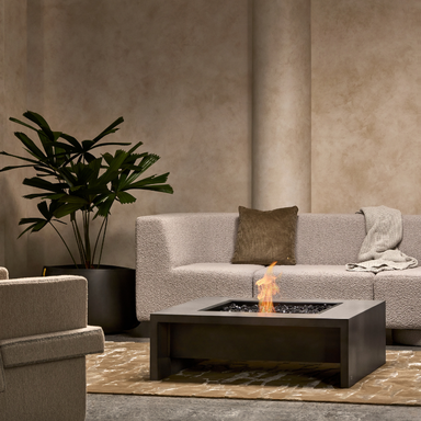 EcoSmart Mojito 40 Fire Table in Natural Fluid concrete styled in a luxury indoor lounge.