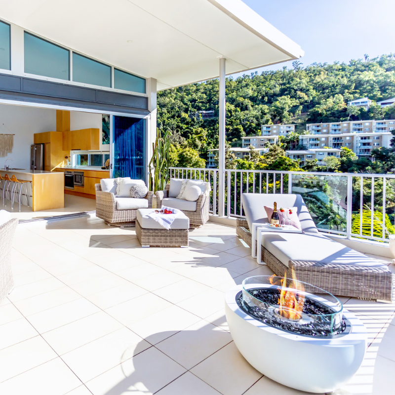 EcoSmart Pod 30 Fire Pit on a luxury balcony terrace with ocean view.