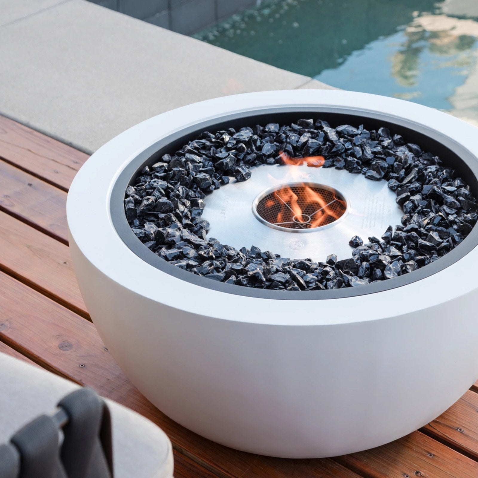 EcoSmart Pod 30 fire pit bowl on a timber poolside deck.
