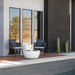 EcoSmart Pod 30 Fire Pit beside a modern pool patio with outdoor lounge chairs.