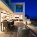 EcoSmart Pod 40 fire pit bowl on an alfresco poolside deck with dining at dusk.