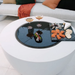 EcoSmart R20 Cover Plate on white round fire pit table used as serving and entertaining surface