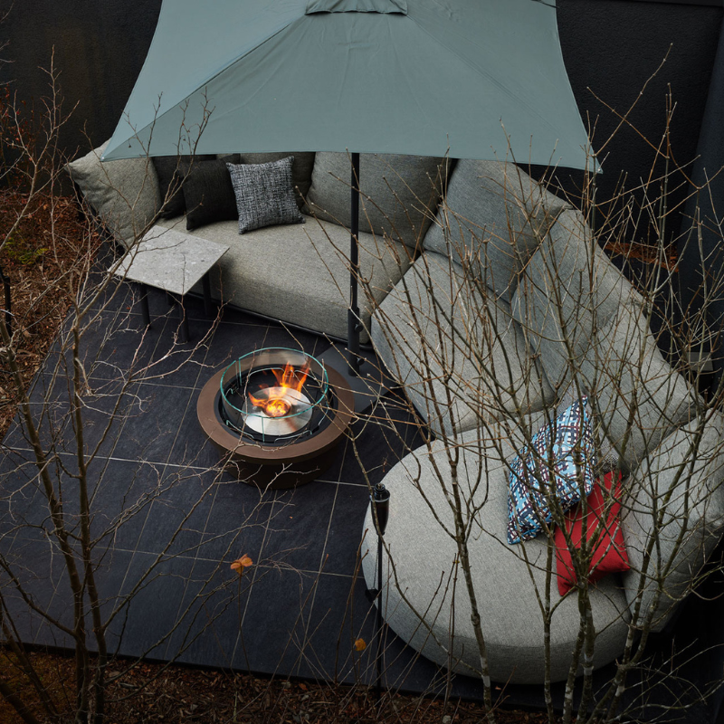EcoSmart Round 20 Fire Pit Kit used in an urban lounge setting, adding warmth and sophistication to the space with its clean, round design