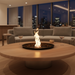 EcoSmart Round 20 Fire Pit Kit placed in an elegant indoor living room, surrounded by modern seating, with a beautiful flame rising from the center.