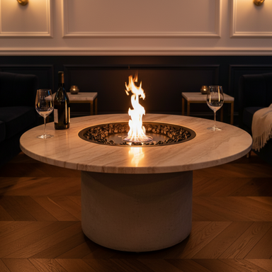 EcoSmart Round 20 Fire Pit Kit in a luxurious living room, featuring a circular design with a flame rising from black stones, surrounded by sophisticated furniture and wine glasses.