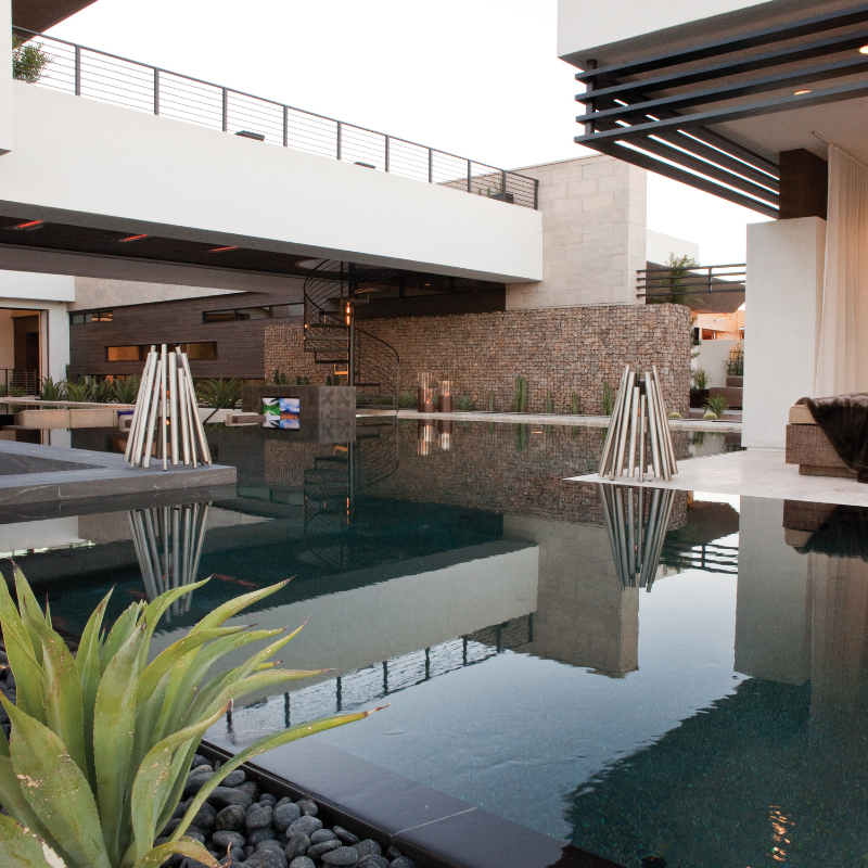 EcoSmart Stix Fire Pit displayed beside pool at modern luxury home with dual fire features