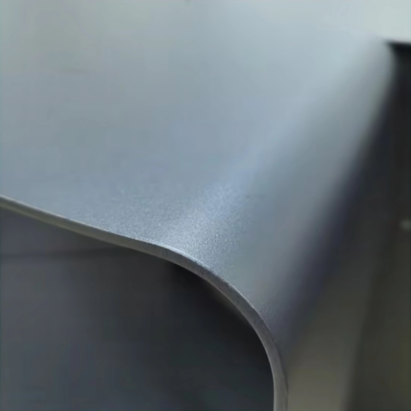Detailed close-up of the Fabrizio Fire Pit’s matte black steel finish and curved edge, showing the material texture and premium construction of the outdoor fire pit.