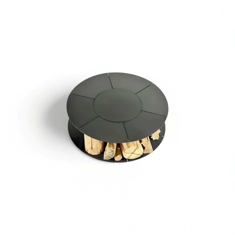 Top-down studio view of the Fabrizio Fire Pit showing its circular black steel top and integrated firewood storage compartment below, presented against a plain background for product detail