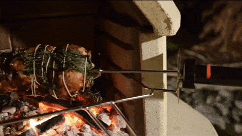 Buschbeck rotisserie turning a roast over the fire
