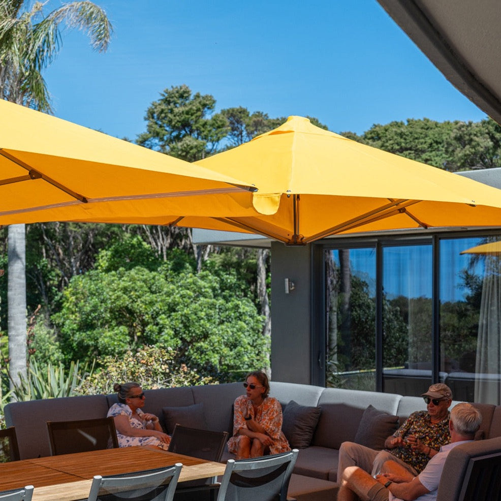 Unity Duo twin canopy umbrella configuration on a covered patio