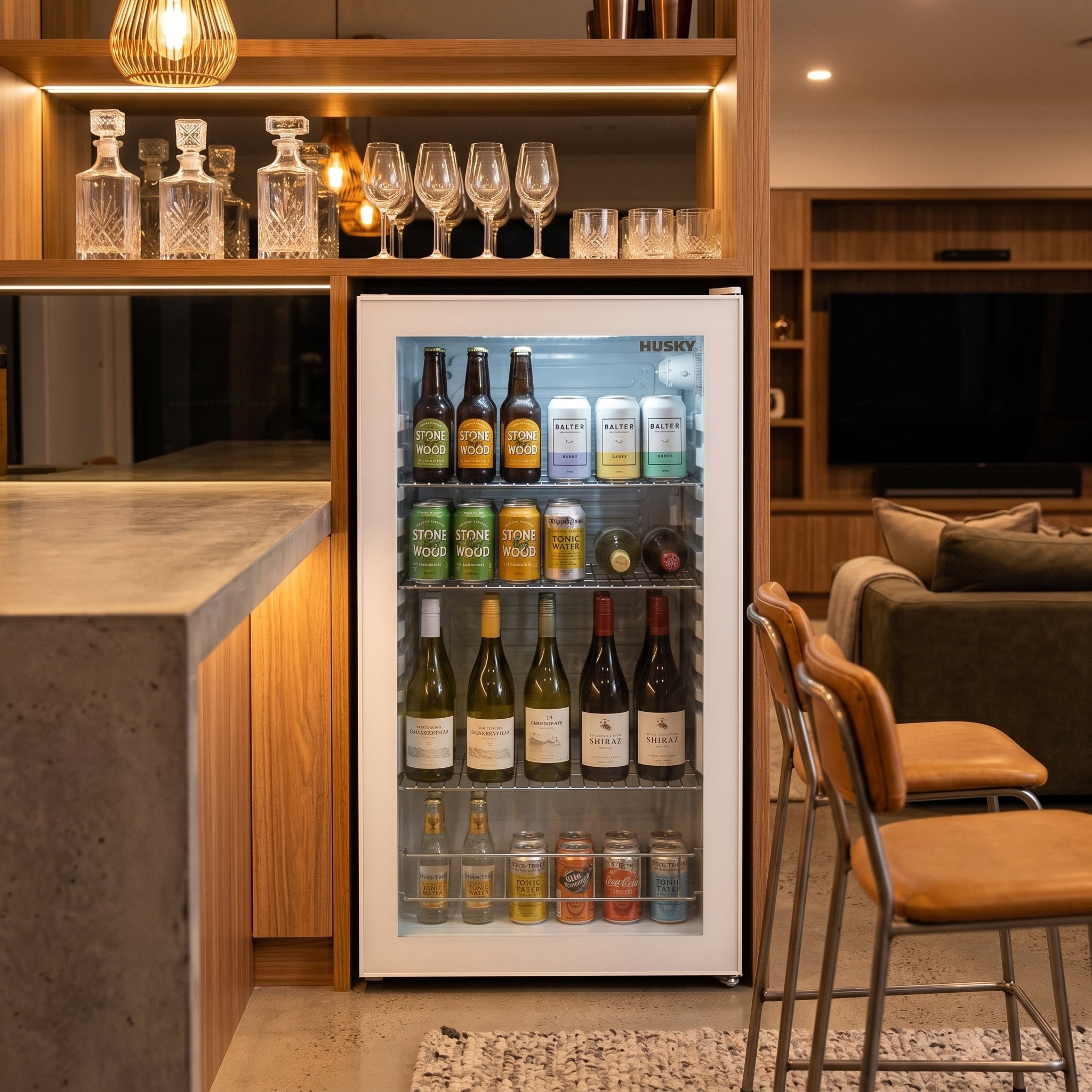Husky 130L glass door bar fridge in a rumpus room home bar stocked with drinks