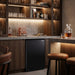 Husky 130L solid door bar fridge built into a dark home bar with glassware above