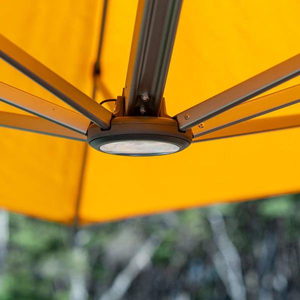 Shadowspec LED light illuminated at the hub of an umbrella canopy
