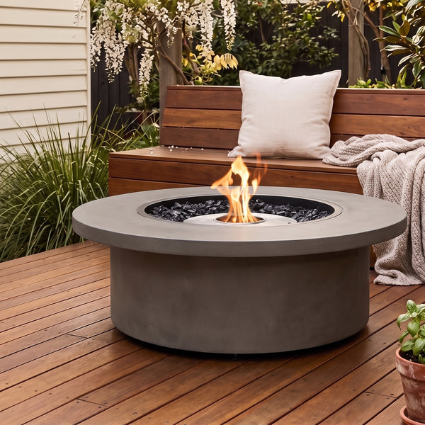 EcoSmart Mimosa 40 Fire Table in Natural / Stainless Steel on a wooden deck with a timber bench, cushion, throw, and wisteria — Australian afternoon light