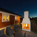 Front product shot of the Ochre Living Hotham Complete Fireplace Kit with fire lit inside the firebox and no lower log storage shown, isolated on a plain background for outdoor fireplace kits Australia.