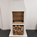 Angled front-right studio image of the Ochre Living Ossa Complete Fireplace Kit with three lower storage openings and a rendered chimney fireplace design on a plain background.