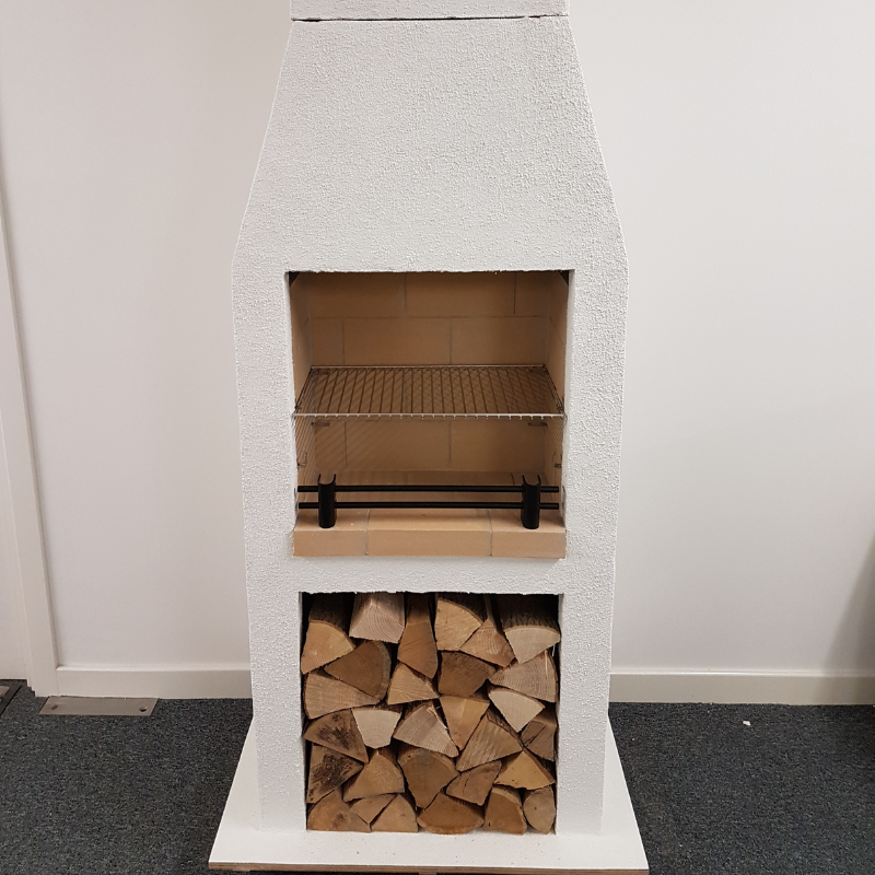 Angled front-right studio image of the Ochre Living Ossa Complete Fireplace Kit with three lower storage openings and a rendered chimney fireplace design on a plain background.