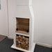 Front view of the Ochre Living Ossa Complete Fireplace Kit displayed indoors in a showroom, with stacked firewood below and a cooking grill fitted inside the firebox.
