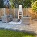 Modern patio setup featuring the Ochre Living Ossa Complete Fireplace Kit with chimney, surrounded by outdoor lounge seating and paving, showing a clean and contemporary outdoor fireplace design ideal for Australian backyards.