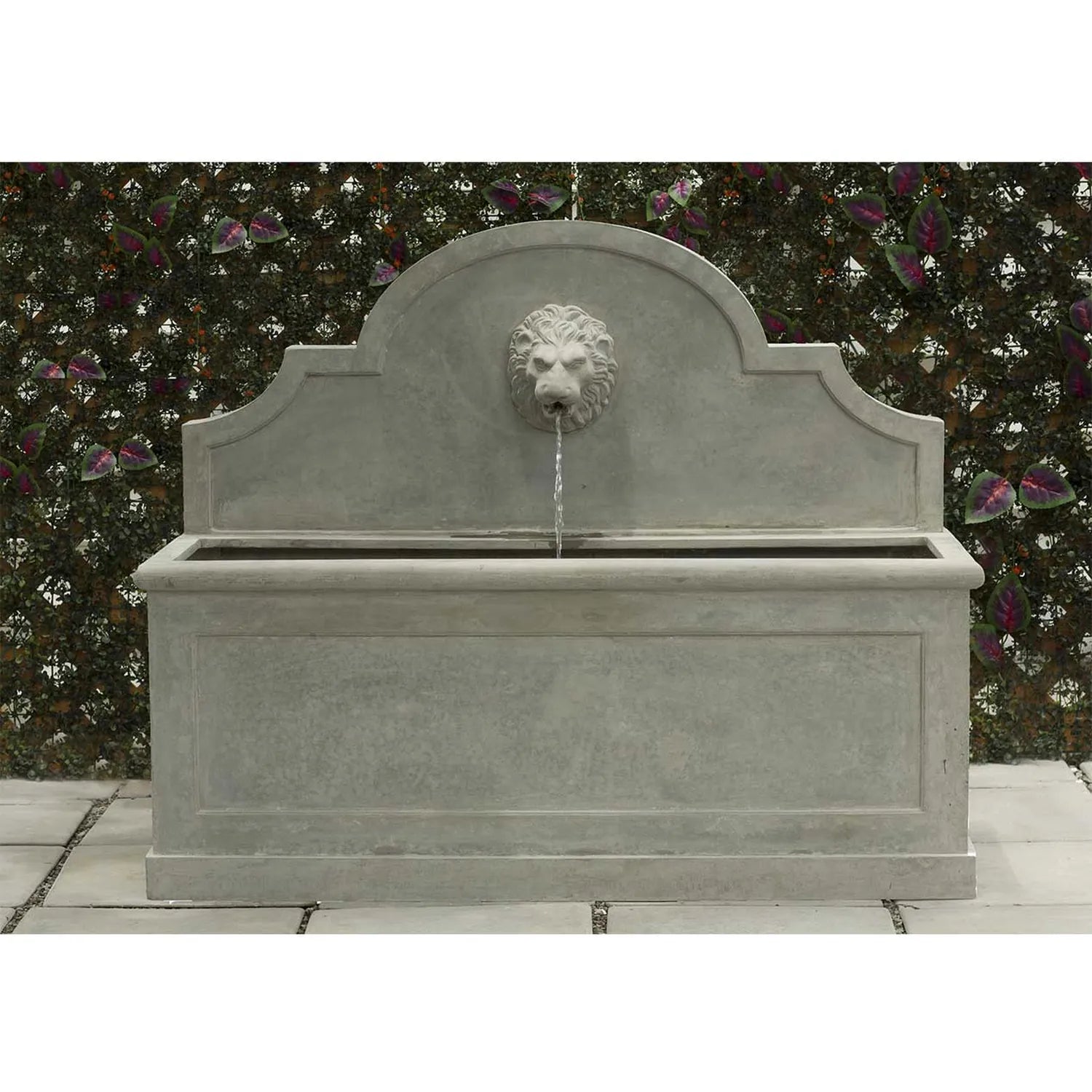 Pietro Stoneware Proven Lion Head Fountain, natural cement, in a courtyard