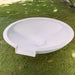 Pietro Stoneware Wok Spillway Bowl, on a garden lawn