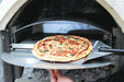 Pizza on a peel at the door of the Buschbeck pizza insert