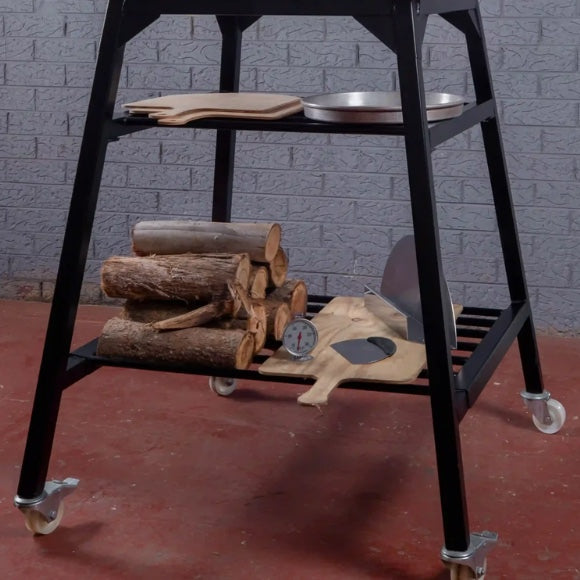 Polito Antonius Tower Stand in black steel with two shelves and four castors; the peels, pan and firewood shown are not included