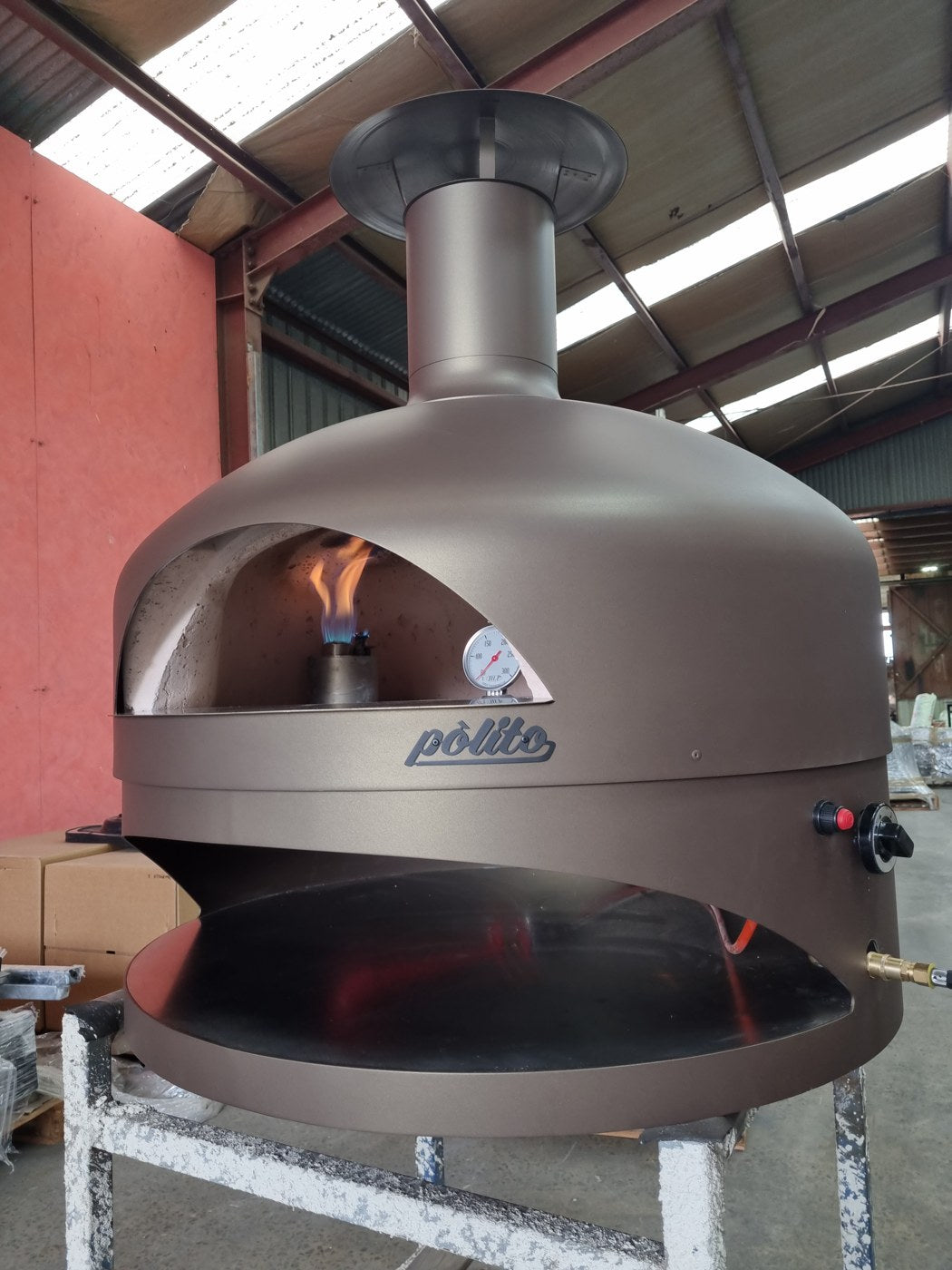 Polito Giotto Gas pizza oven with the gas burner lit in the centre of the cooking floor