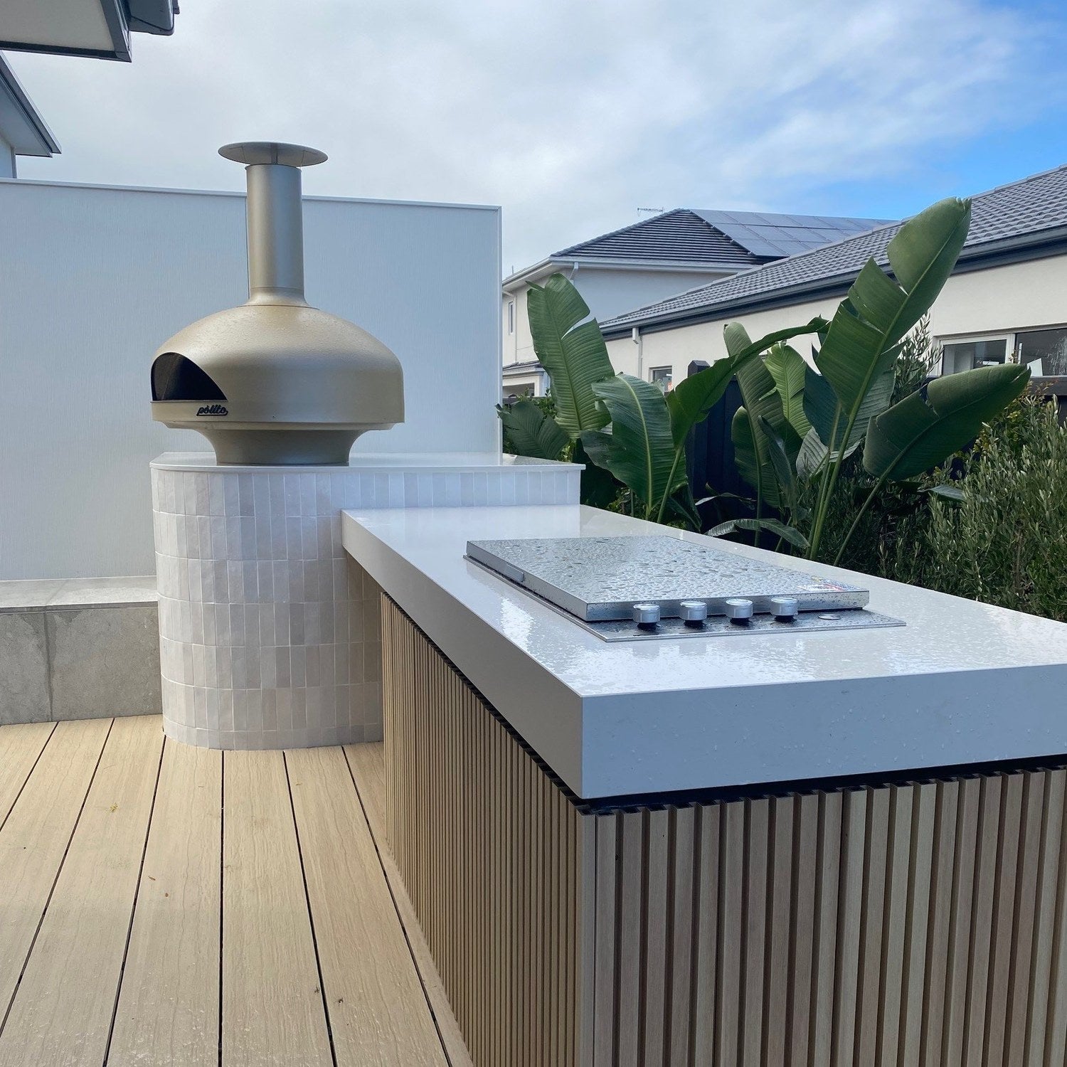 Polito Giotto in Champagne on a stone bench beside an outdoor kitchen