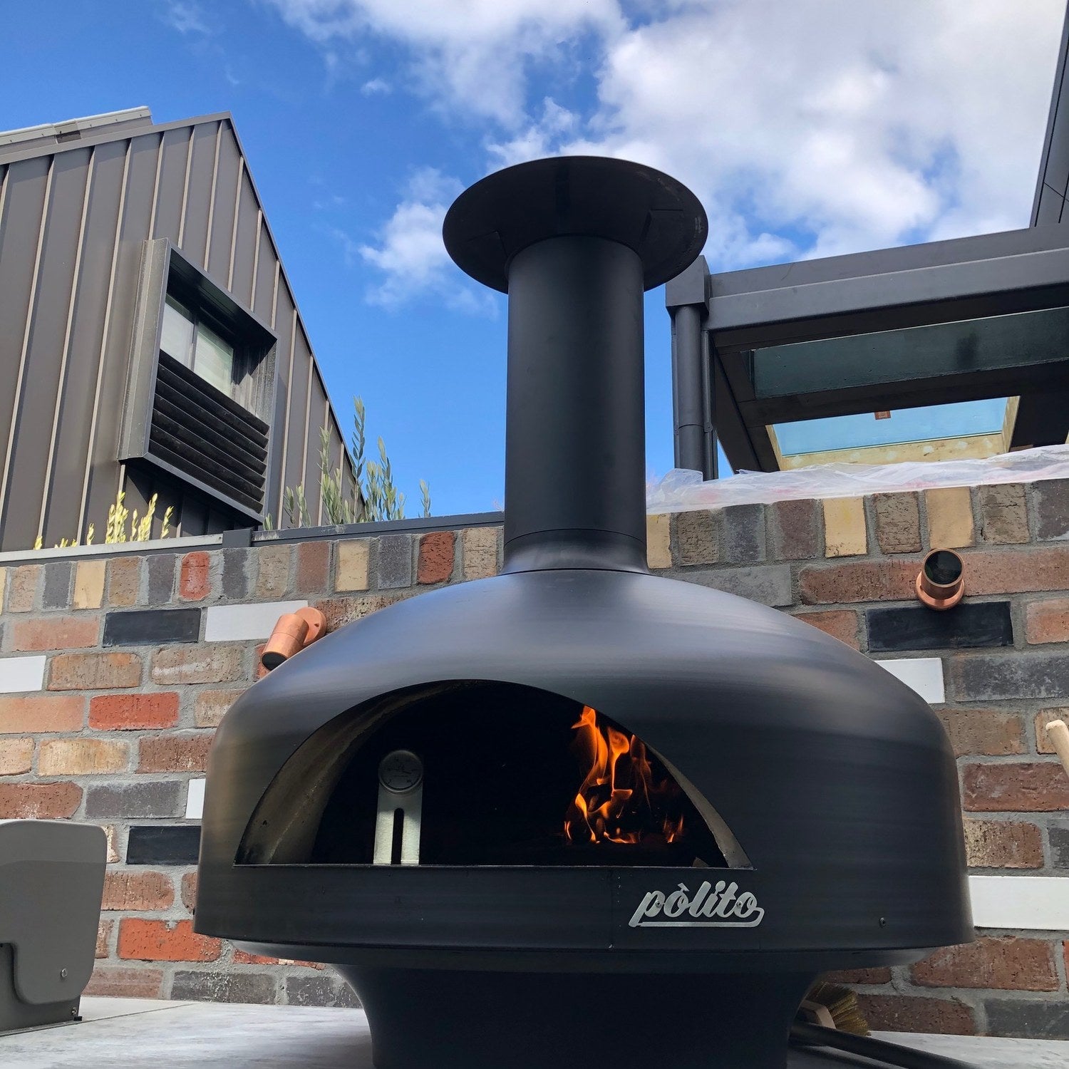 Polito Giotto in Black with a wood fire burning in the chamber
