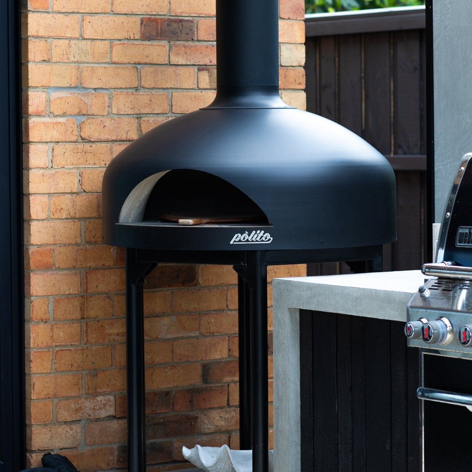 Polito Giotto in Black installed in an outdoor kitchen beside a barbecue