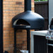 Polito Giotto in Black installed in an outdoor kitchen beside a barbecue