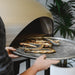 Polito Giotto wood fire pizza oven in champagne finish — lifestyle scene — My Acre