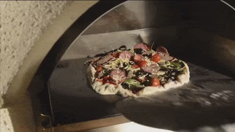 Pizza baking on the soapstone inside the Buschbeck pizza insert