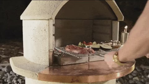 Buschbeck fireplace with the pizza insert fitted and a pizza on the mantle