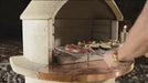 Buschbeck fireplace with the pizza insert fitted and a pizza on the mantle