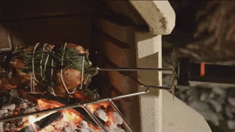 Buschbeck rotisserie turning a roast over the fire