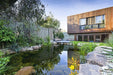 An Aquascape recreation pond in a landscaped garden setting